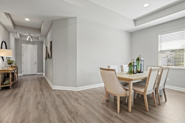 dining area featuring a textured ceiling and light wood-type flooring