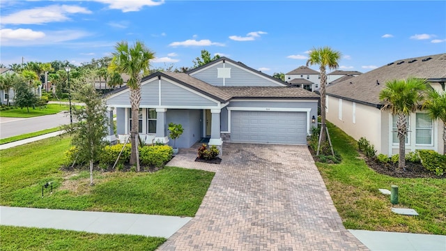 view of front of property featuring a garage and a front lawn