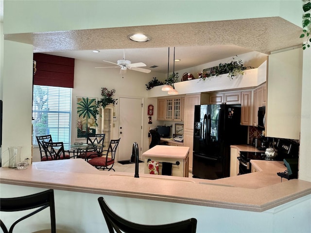 5658 Downham Mdws, Sarasota, FL 34235 - kitchen with recessed lighting, glass insert cabinets, a ceiling fan, a kitchen bar, and black appliances