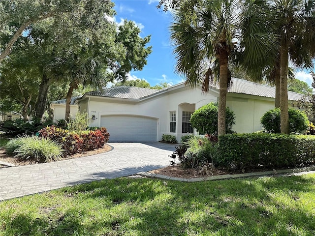 view of front of home with a front yard and a garage