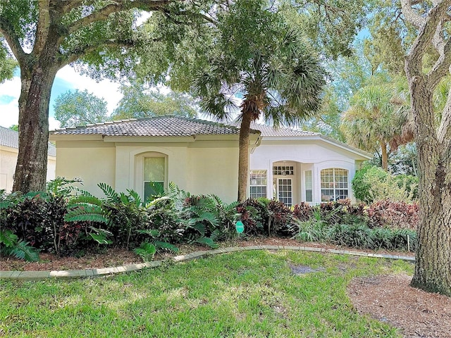 mediterranean / spanish house with a front lawn