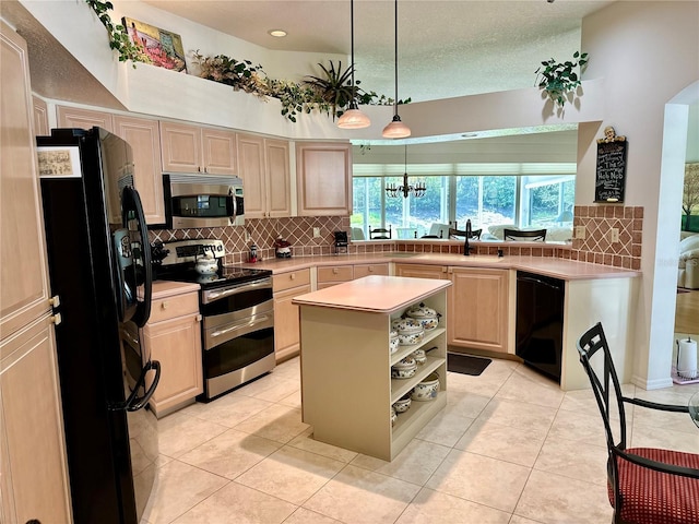 kitchen featuring hanging light fixtures, tasteful backsplash, a kitchen island, light tile patterned floors, and black appliances