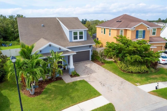 view of front of house with a garage and a front yard