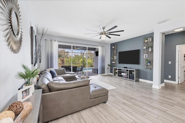 living room featuring ceiling fan and light wood-type flooring