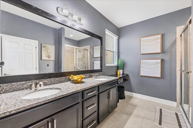 bathroom with tile patterned flooring, vanity, and an enclosed shower