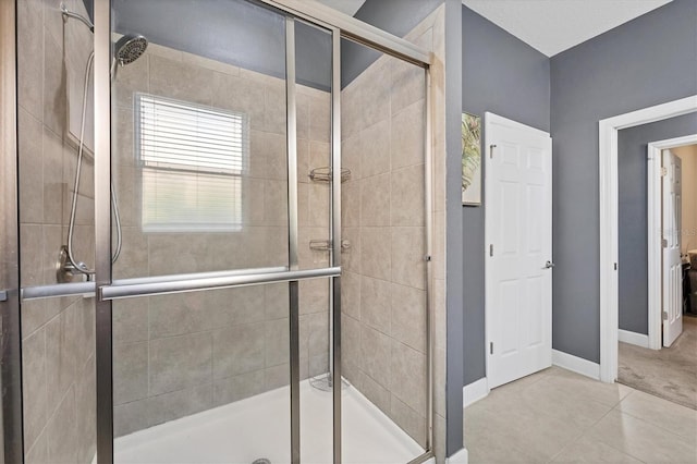 bathroom featuring tile patterned floors and an enclosed shower