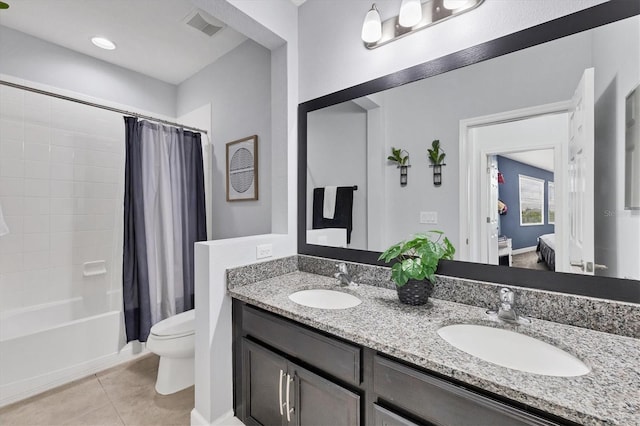 full bathroom with tile patterned floors, shower / bath combo, vanity, and toilet