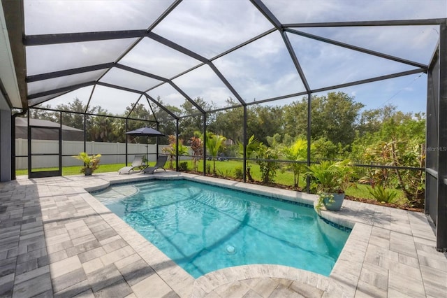 view of swimming pool with glass enclosure and a patio area