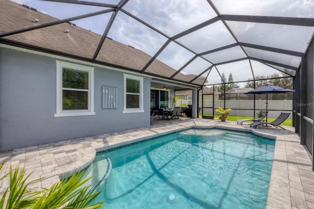 view of pool with a patio and glass enclosure