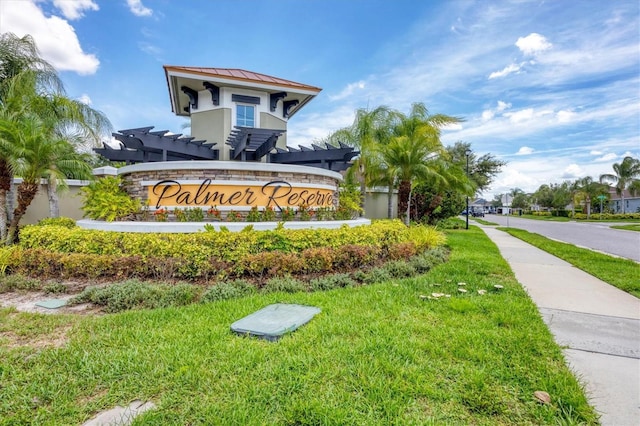 community sign featuring a lawn