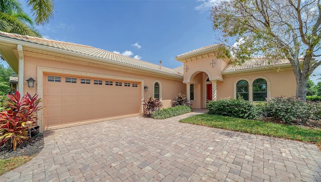 mediterranean / spanish-style home featuring a garage