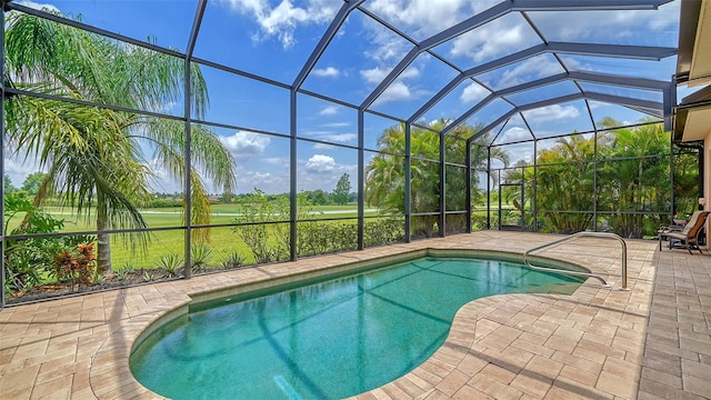 view of swimming pool with a lanai and a patio area