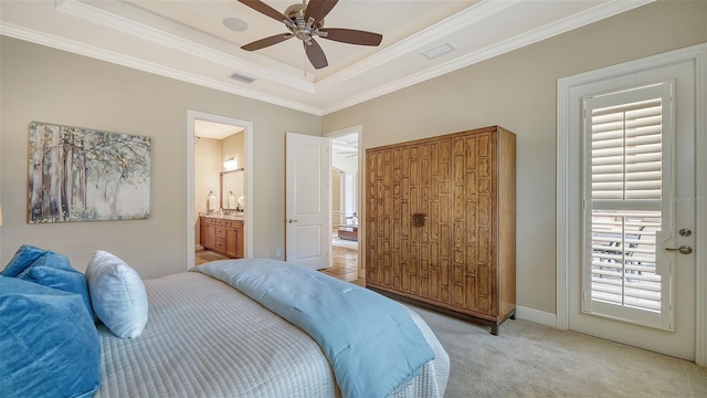 bedroom with ornamental molding, connected bathroom, ceiling fan, and light carpet