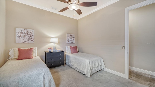 bedroom with ceiling fan, light colored carpet, and crown molding