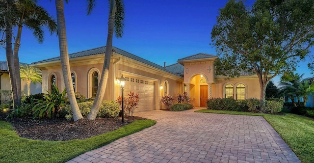 mediterranean / spanish-style house with a garage