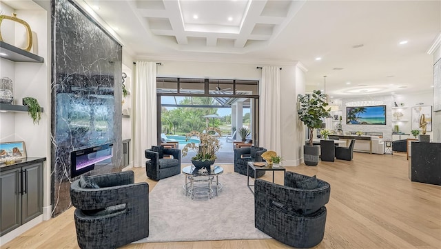 living room with ornamental molding, light hardwood / wood-style floors, and a high end fireplace