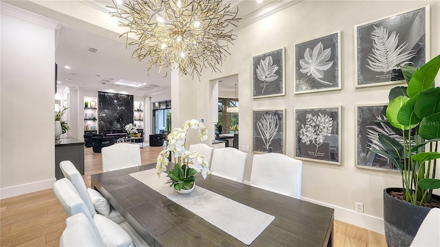 dining room featuring an inviting chandelier, ornamental molding, and hardwood / wood-style floors