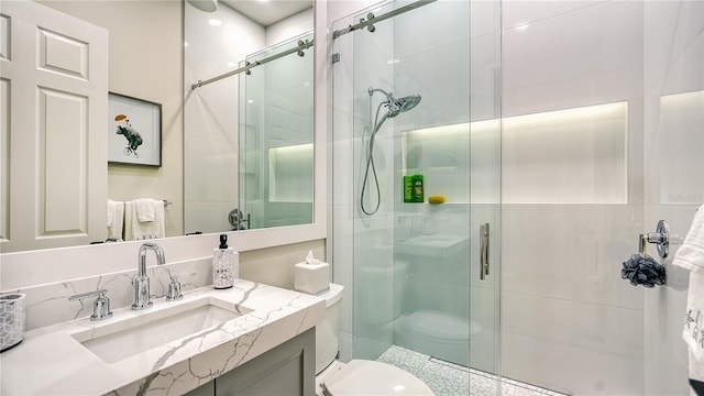 bathroom with vanity, toilet, and an enclosed shower