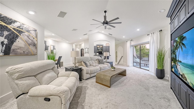 living room featuring vaulted ceiling, ceiling fan, and light carpet