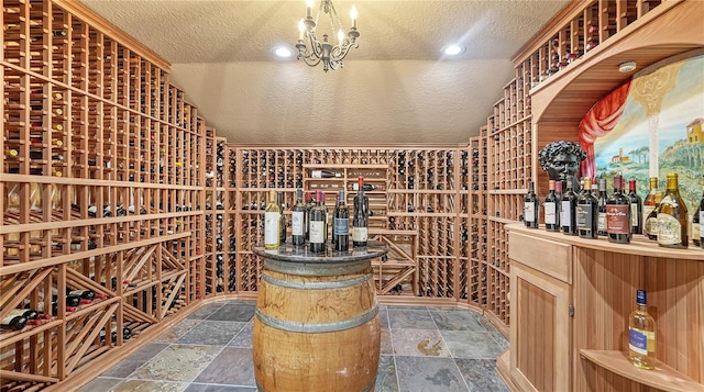 wine room featuring a textured ceiling, lofted ceiling, and an inviting chandelier