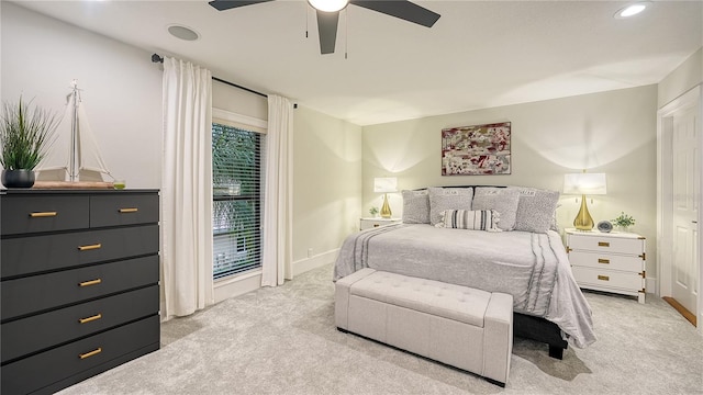 bedroom featuring light carpet and ceiling fan