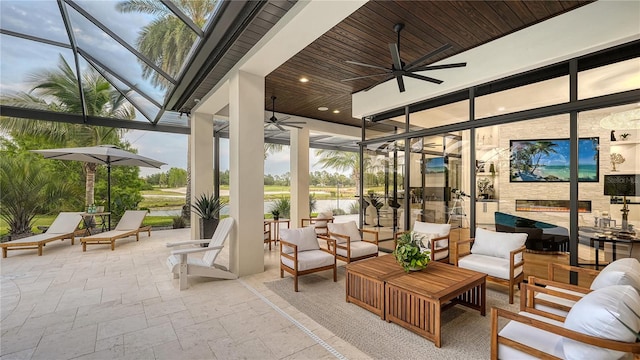 sunroom / solarium with wooden ceiling and ceiling fan