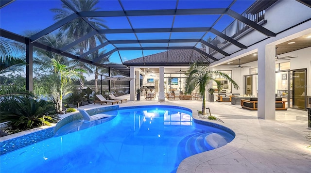 view of swimming pool with ceiling fan, a patio, a lanai, and an outdoor living space