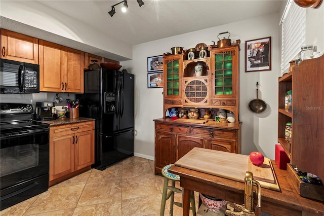 kitchen featuring light tile patterned flooring and black appliances