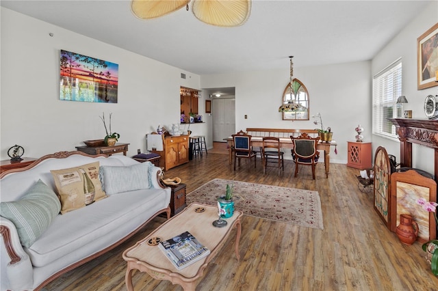 living room with an inviting chandelier and hardwood / wood-style floors