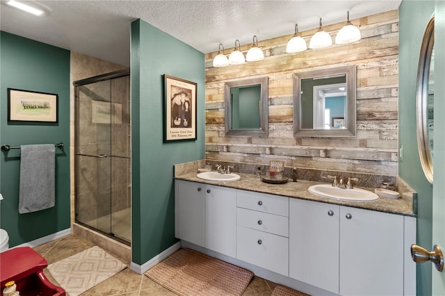 bathroom with vanity, tile patterned floors, a textured ceiling, and an enclosed shower