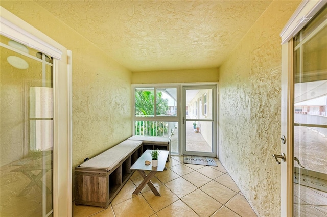 entryway with light tile patterned flooring