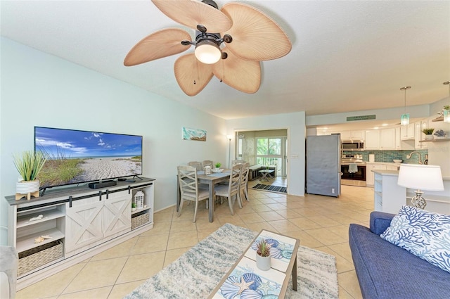 living room featuring ceiling fan and light tile patterned floors