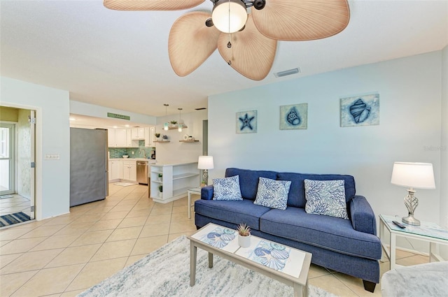 living room featuring light tile patterned flooring and ceiling fan