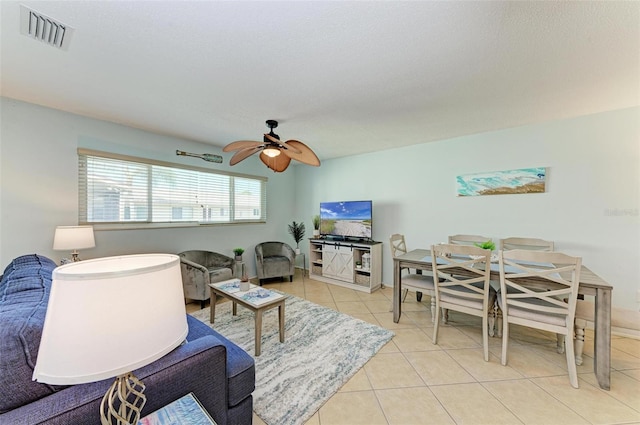 tiled living room with ceiling fan