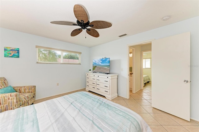 bedroom featuring visible vents, baseboards, ceiling fan, and light tile patterned floors