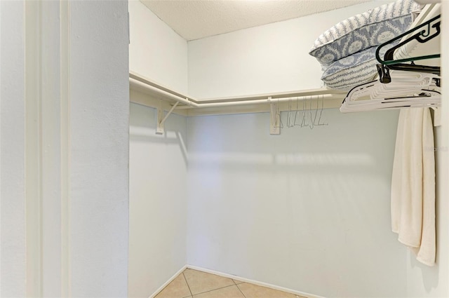 walk in closet featuring light tile patterned floors