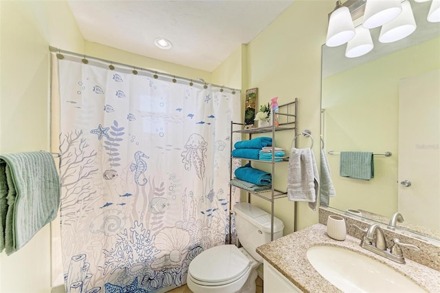 bathroom featuring a shower with curtain, vanity, and toilet