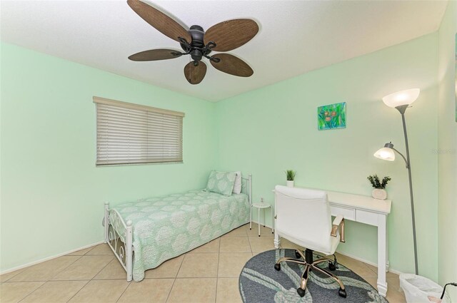 bedroom with baseboards, tile patterned flooring, and a ceiling fan