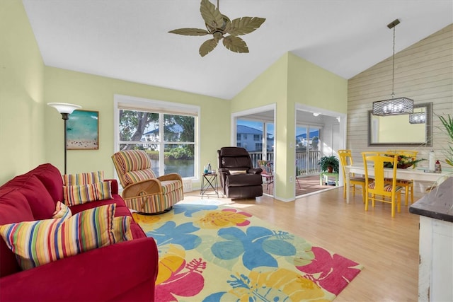 living room featuring vaulted ceiling, ceiling fan, and light hardwood / wood-style flooring