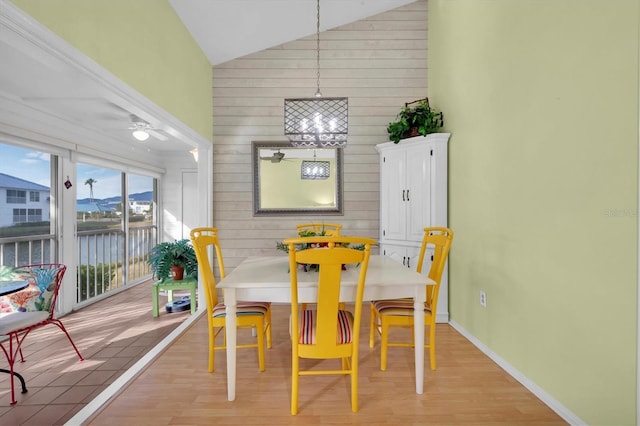 dining space featuring vaulted ceiling, ceiling fan, and light hardwood / wood-style flooring