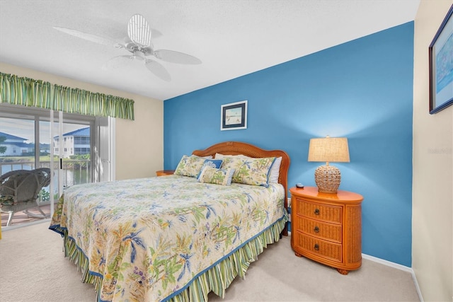 bedroom with a textured ceiling, access to outside, ceiling fan, and carpet flooring