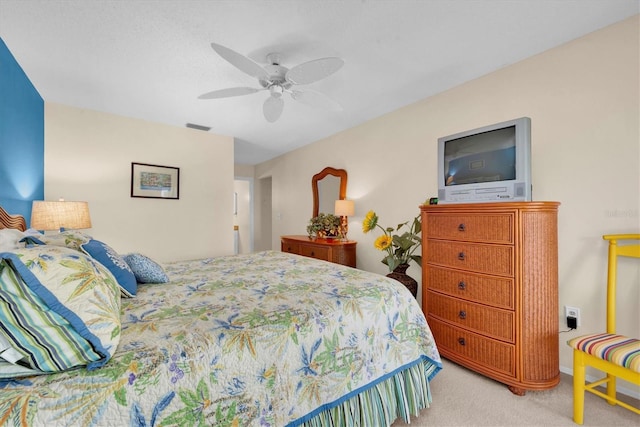 bedroom featuring light carpet and ceiling fan