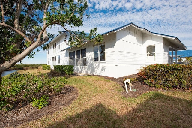 view of side of home featuring a lawn