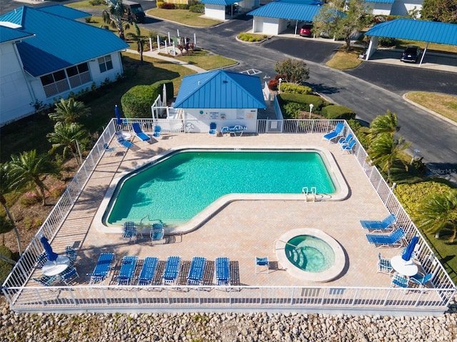 view of pool with a patio area and a hot tub