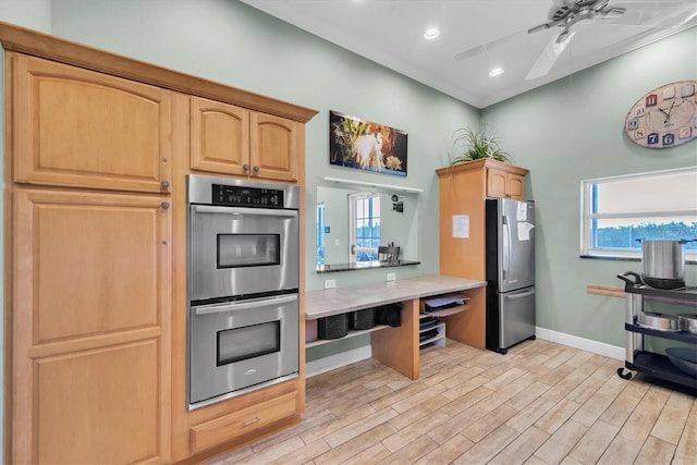 kitchen featuring ceiling fan, stainless steel appliances, light brown cabinetry, and light wood-type flooring