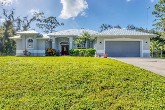 view of front of home with an attached garage, metal roof, a front lawn, and stucco siding