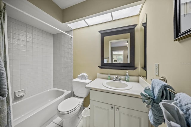 full bathroom with vanity, tile patterned flooring, shower / bath combo, a skylight, and toilet