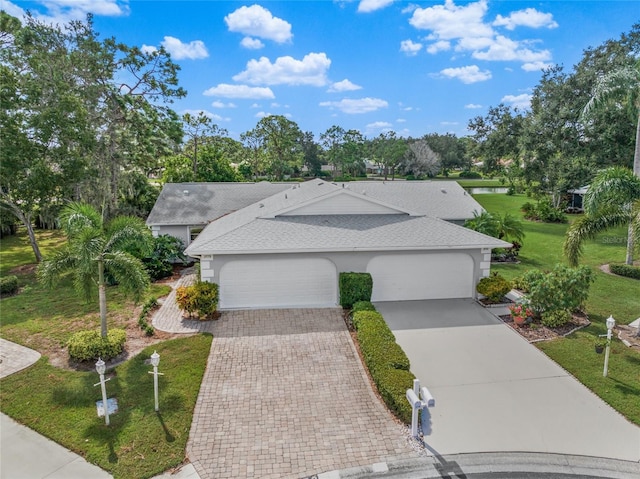 view of front of house with a garage and a front yard