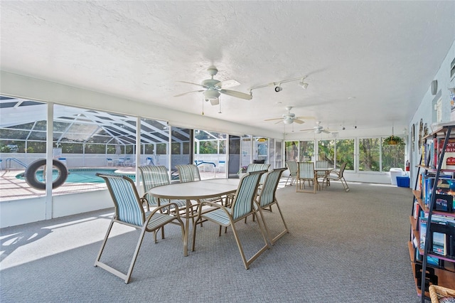 sunroom / solarium featuring ceiling fan