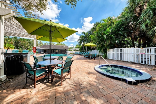 view of patio featuring a pool with hot tub